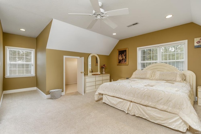 carpeted bedroom with ceiling fan and vaulted ceiling