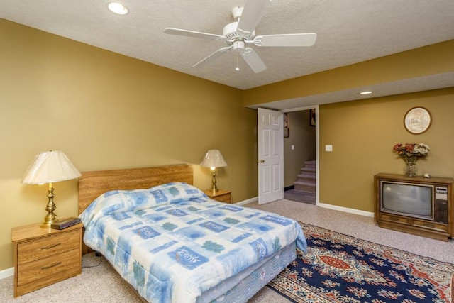 bedroom with carpet flooring, a textured ceiling, and ceiling fan