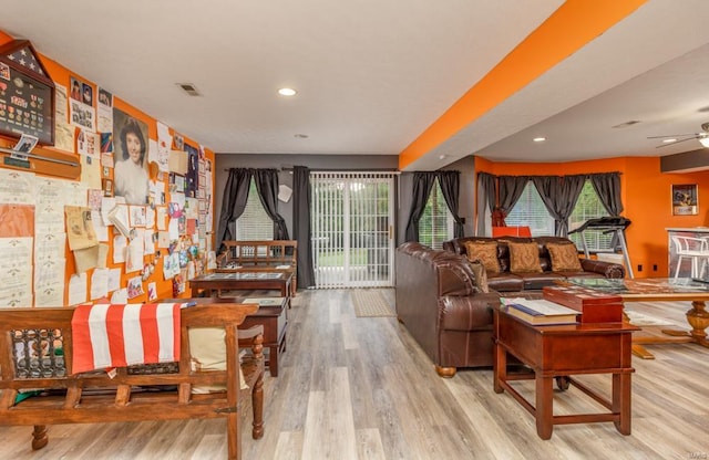 living room with light hardwood / wood-style flooring, a wealth of natural light, and ceiling fan