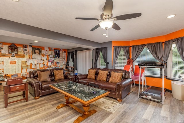 living room featuring hardwood / wood-style flooring and ceiling fan