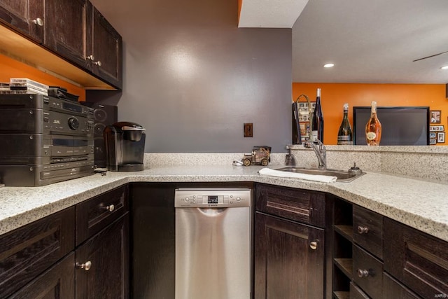 kitchen featuring light stone counters, dark brown cabinets, sink, and stainless steel dishwasher