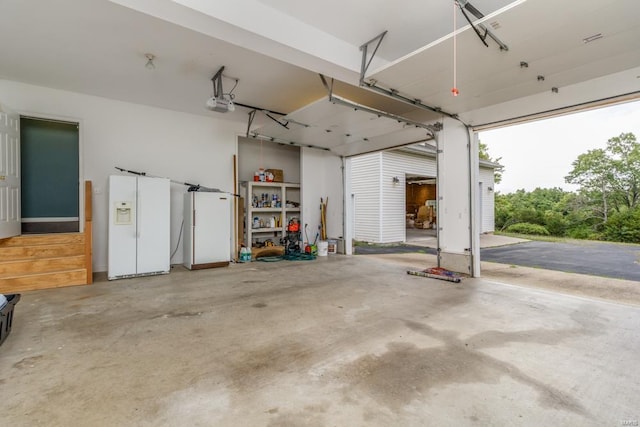 garage with white fridge with ice dispenser and a garage door opener