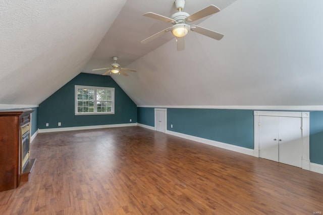 bonus room featuring lofted ceiling, hardwood / wood-style floors, and ceiling fan