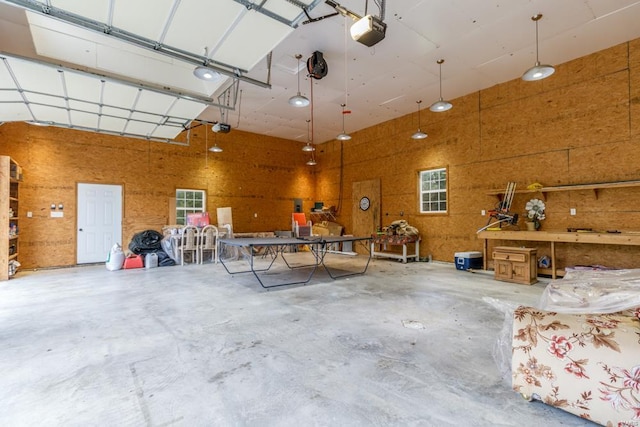 garage featuring a garage door opener and a workshop area