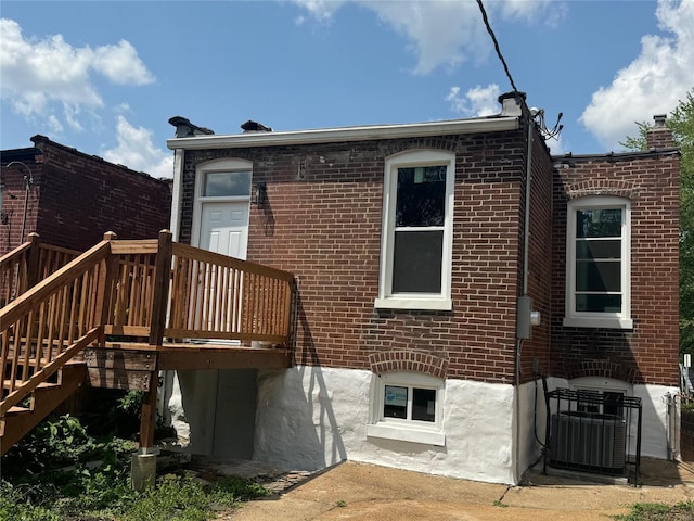 back of property featuring cooling unit and a deck