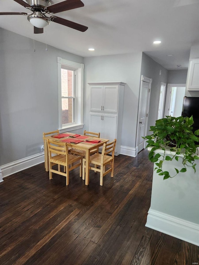 dining area with dark hardwood / wood-style flooring and ceiling fan