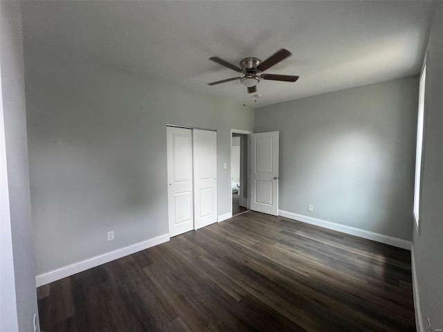 unfurnished bedroom featuring dark hardwood / wood-style flooring, a closet, and ceiling fan