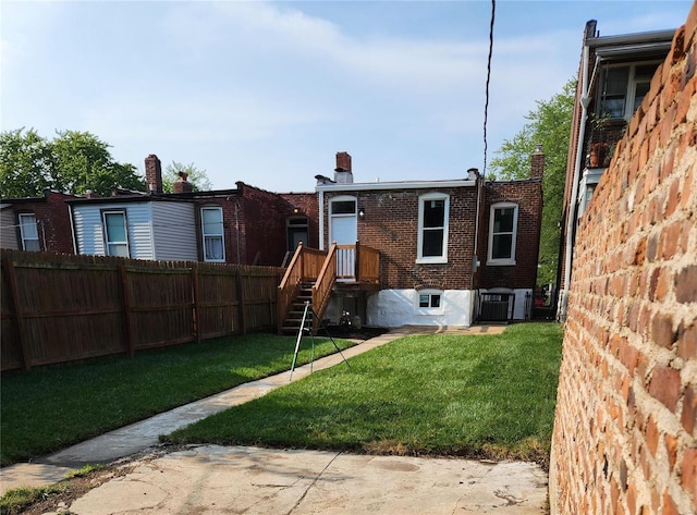 rear view of house with a yard