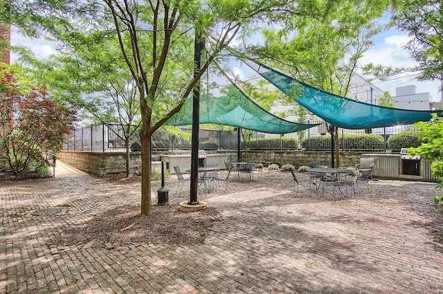 view of community featuring exterior bar and a patio area