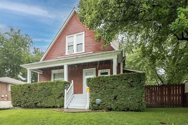 view of front of property featuring covered porch and a front yard