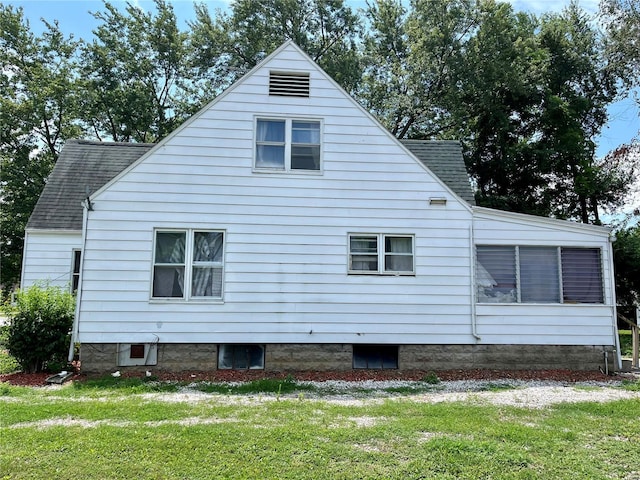 view of side of home with a lawn