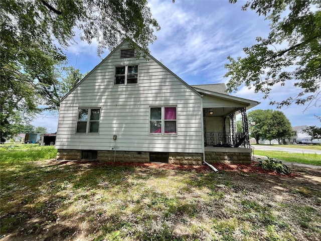 view of property exterior featuring covered porch