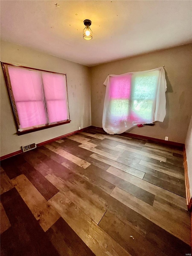 unfurnished room with hardwood / wood-style flooring