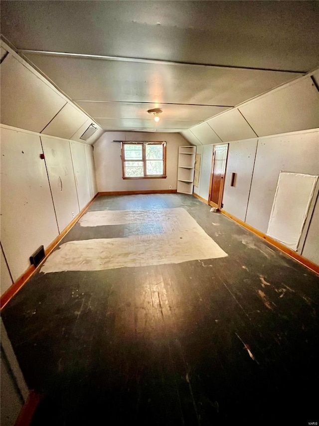 bonus room with vaulted ceiling and light hardwood / wood-style floors