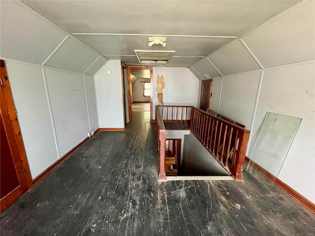 bonus room with dark hardwood / wood-style flooring and lofted ceiling