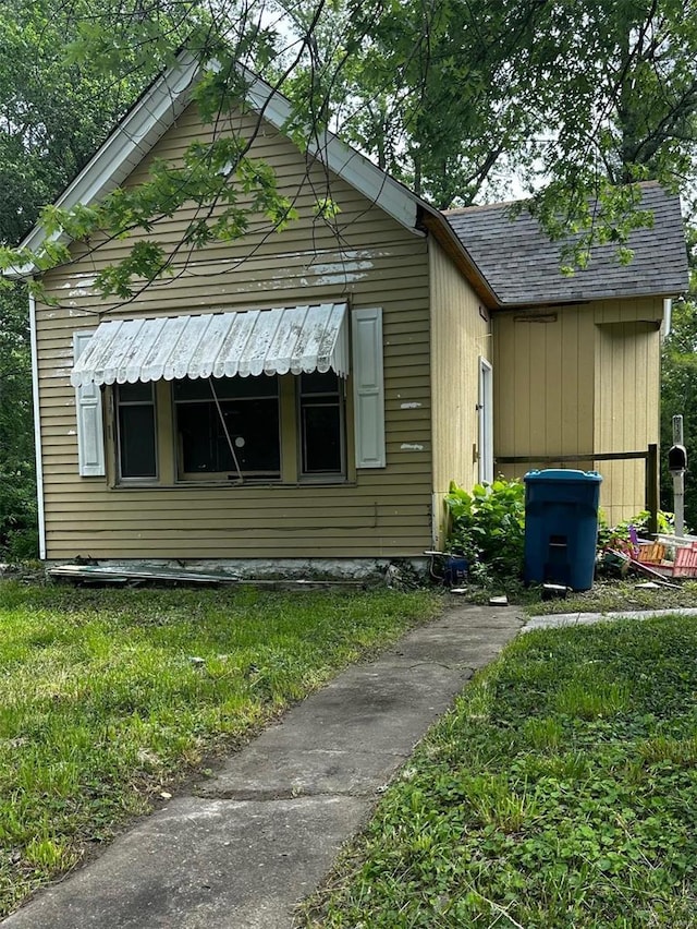 view of side of home with a lawn