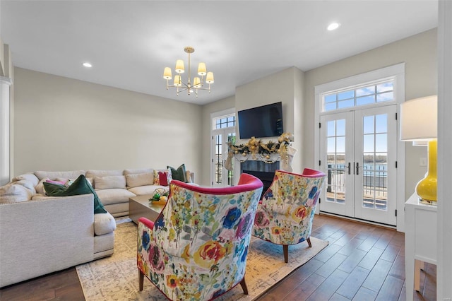 living room with french doors, wood finished floors, and a healthy amount of sunlight