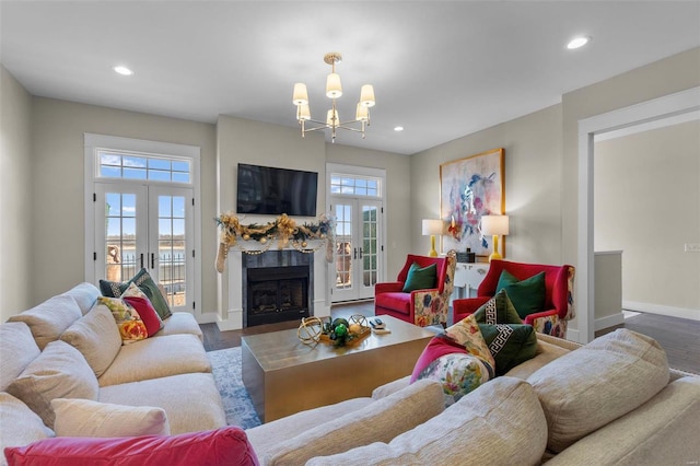 living room featuring recessed lighting, french doors, baseboards, and wood finished floors