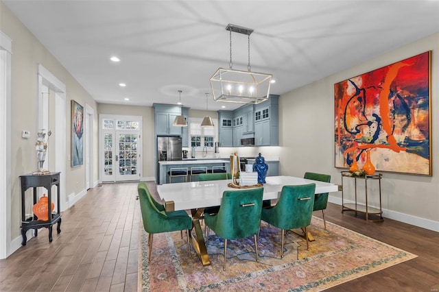 dining space featuring recessed lighting, baseboards, and wood finished floors