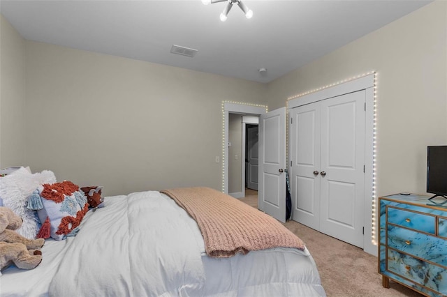 bedroom with light carpet, a closet, and visible vents