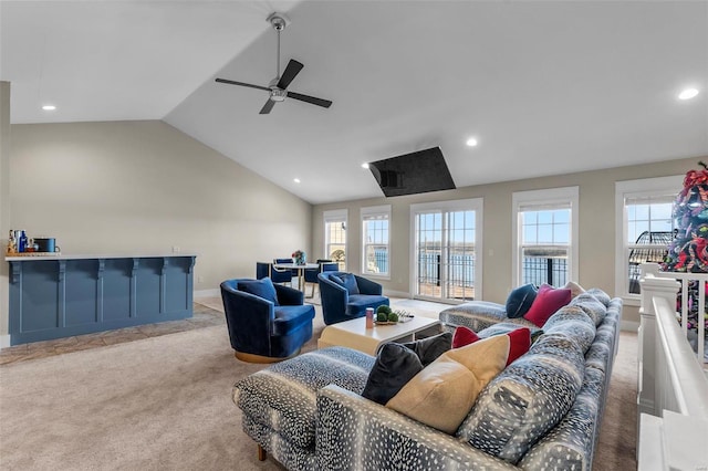 living area with light carpet, vaulted ceiling, a wealth of natural light, and recessed lighting