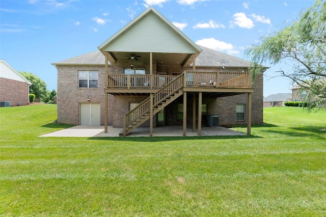 rear view of house featuring a yard, a patio, and ceiling fan