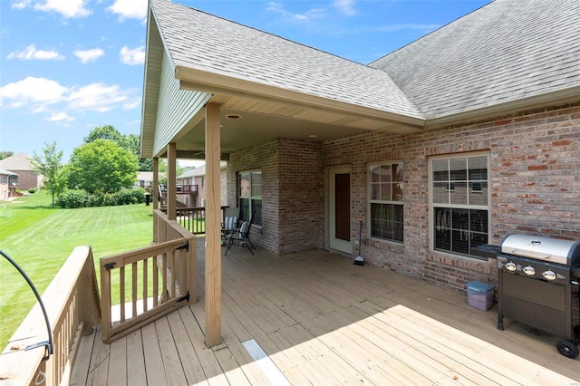 deck with a lawn and a grill