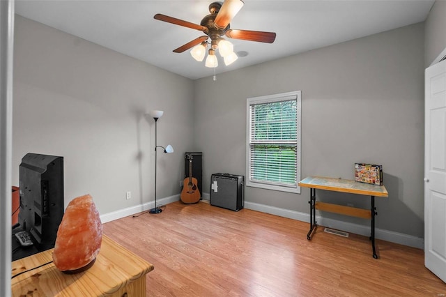 office with ceiling fan and light hardwood / wood-style flooring