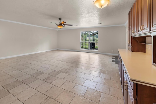 interior space with a textured ceiling, ornamental molding, light tile patterned floors, and ceiling fan