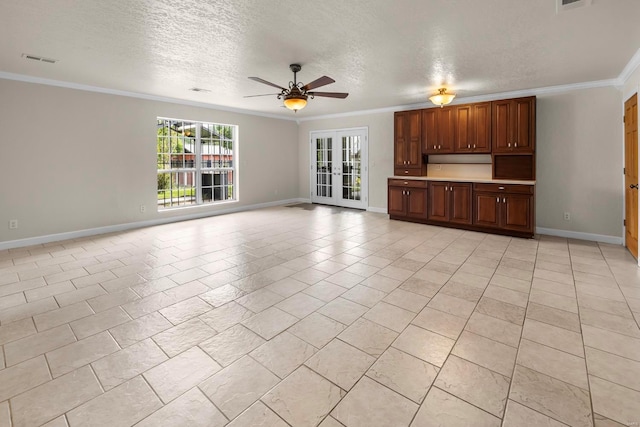 unfurnished living room featuring ceiling fan, ornamental molding, french doors, a textured ceiling, and light tile patterned floors