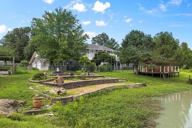 exterior space with a water view and a lawn