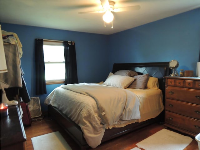 bedroom featuring ceiling fan and dark hardwood / wood-style floors