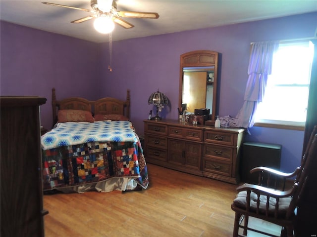 bedroom with light wood-type flooring and ceiling fan