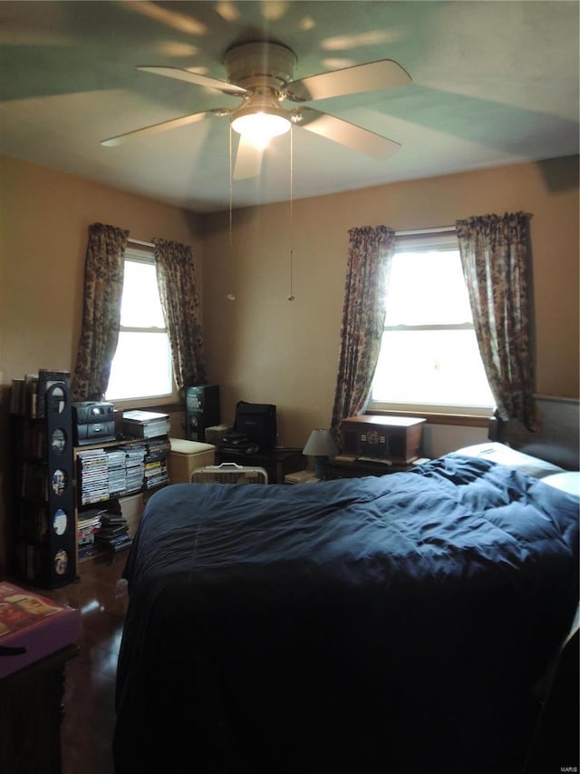 bedroom with ceiling fan and multiple windows