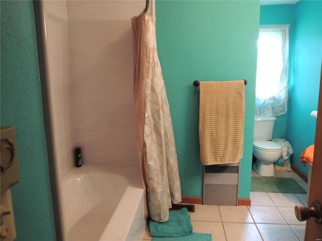 bathroom with shower / bath combo, tile patterned floors, and toilet