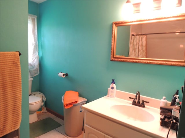 bathroom featuring toilet, vanity, and tile patterned flooring