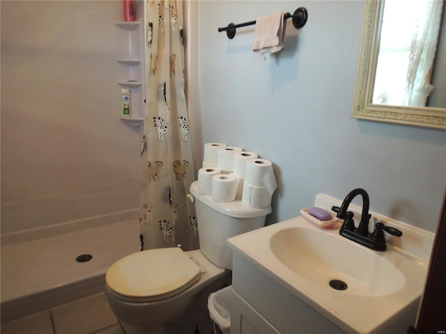 bathroom featuring toilet, tile patterned flooring, walk in shower, and vanity