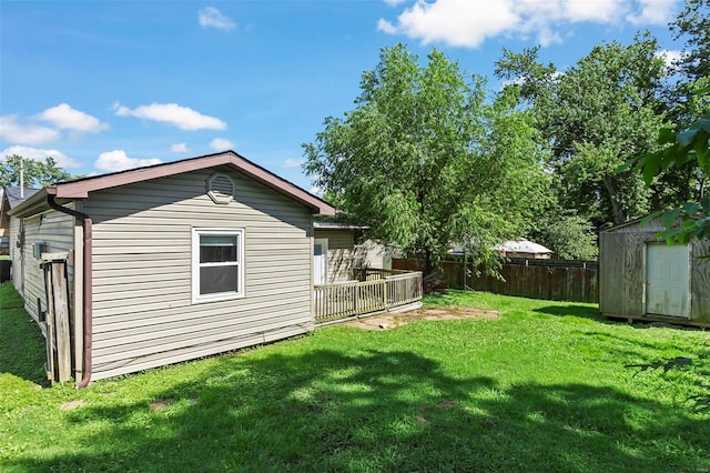 view of yard with a wooden deck and a storage shed