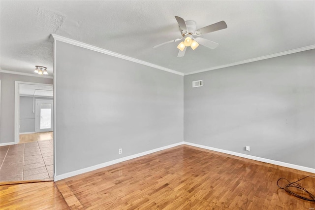 empty room featuring a textured ceiling, hardwood / wood-style flooring, ceiling fan, and crown molding