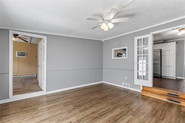 spare room featuring ornamental molding, a textured ceiling, ceiling fan, dark wood-type flooring, and an AC wall unit