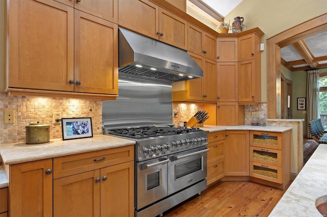 kitchen with decorative backsplash, light wood-type flooring, and double oven range