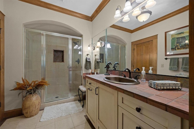 bathroom featuring vanity, ornamental molding, a notable chandelier, tile patterned flooring, and a shower with door