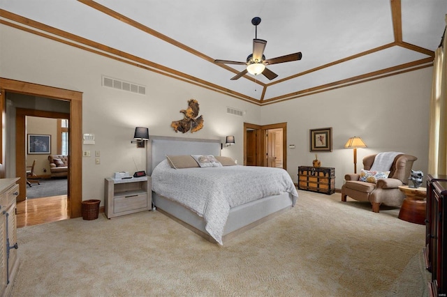 carpeted bedroom with lofted ceiling, ornamental molding, and ceiling fan