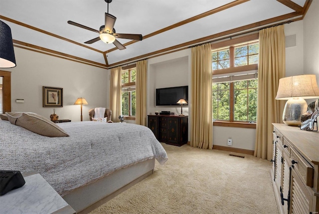 carpeted bedroom with ceiling fan, ornamental molding, and multiple windows