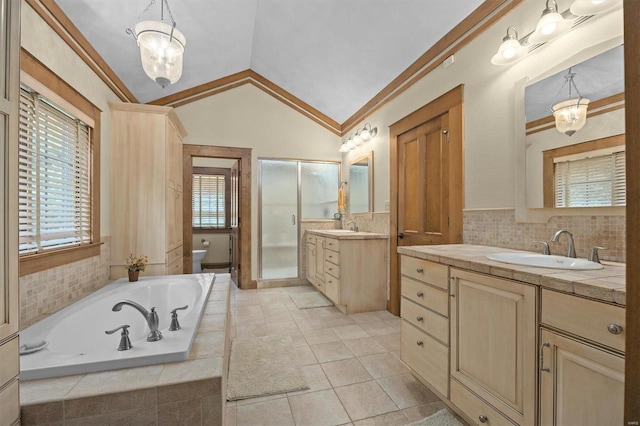 full bathroom with vaulted ceiling, vanity, independent shower and bath, crown molding, and toilet