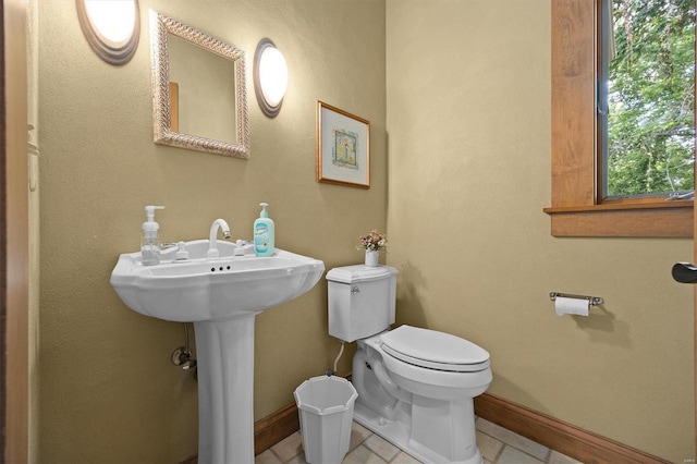 bathroom with tile patterned flooring and toilet