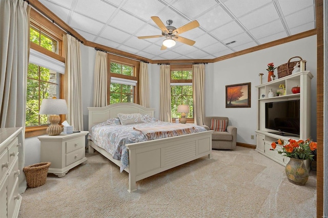 carpeted bedroom featuring ornamental molding, multiple windows, and ceiling fan