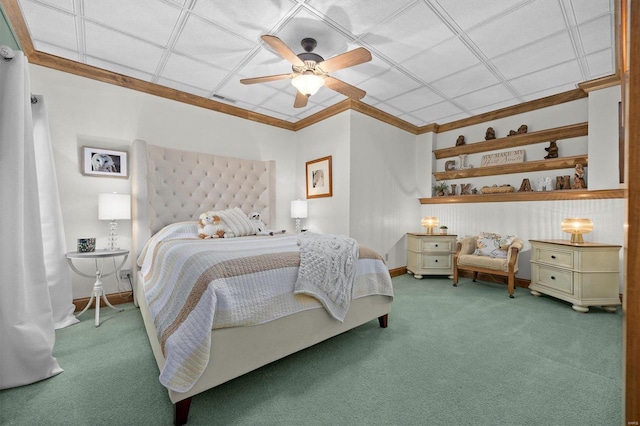 carpeted bedroom featuring ceiling fan and crown molding