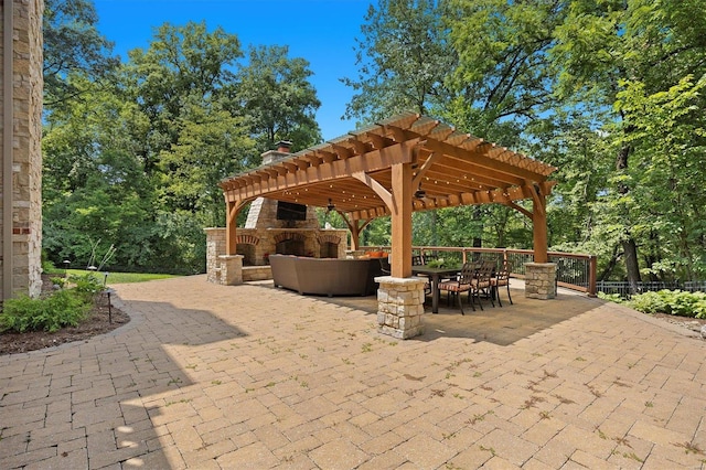 view of patio with a pergola and an outdoor stone fireplace