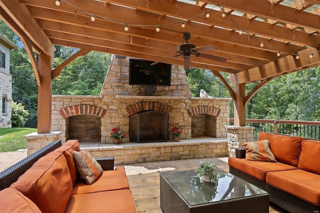 view of patio featuring ceiling fan, an outdoor living space with a fireplace, and a pergola